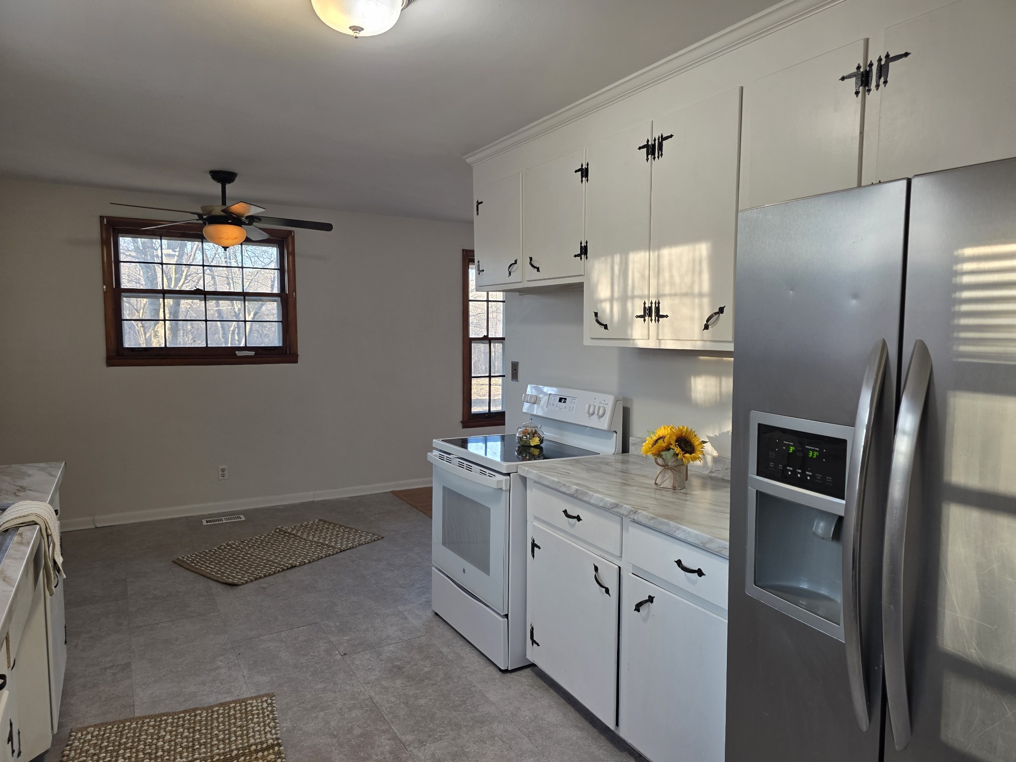 1497 Mt Pleasant Road Kingston Springs, TN 37082 - Photo 10 of 25 a kitchen with stainless steel appliances a refrigerator sink and cabinets