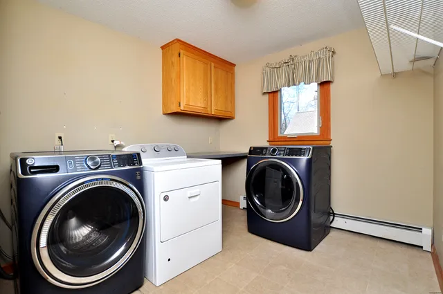a utility room with sink dryer and washer