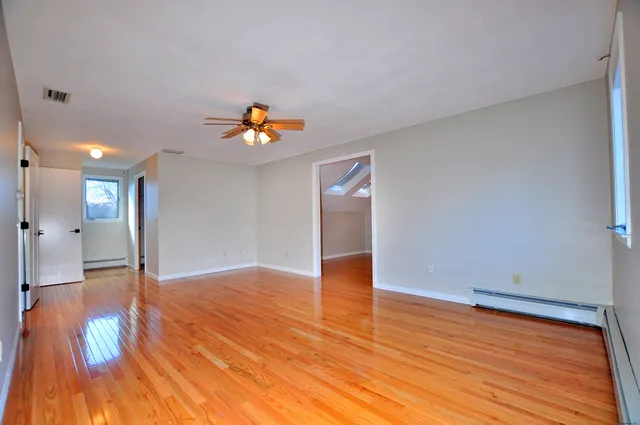 a view of an empty room and wooden floor