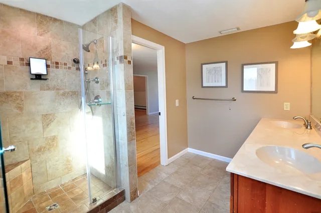 a bathroom with a tub sink and mirror