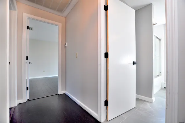 a view of a hallway with wooden floor