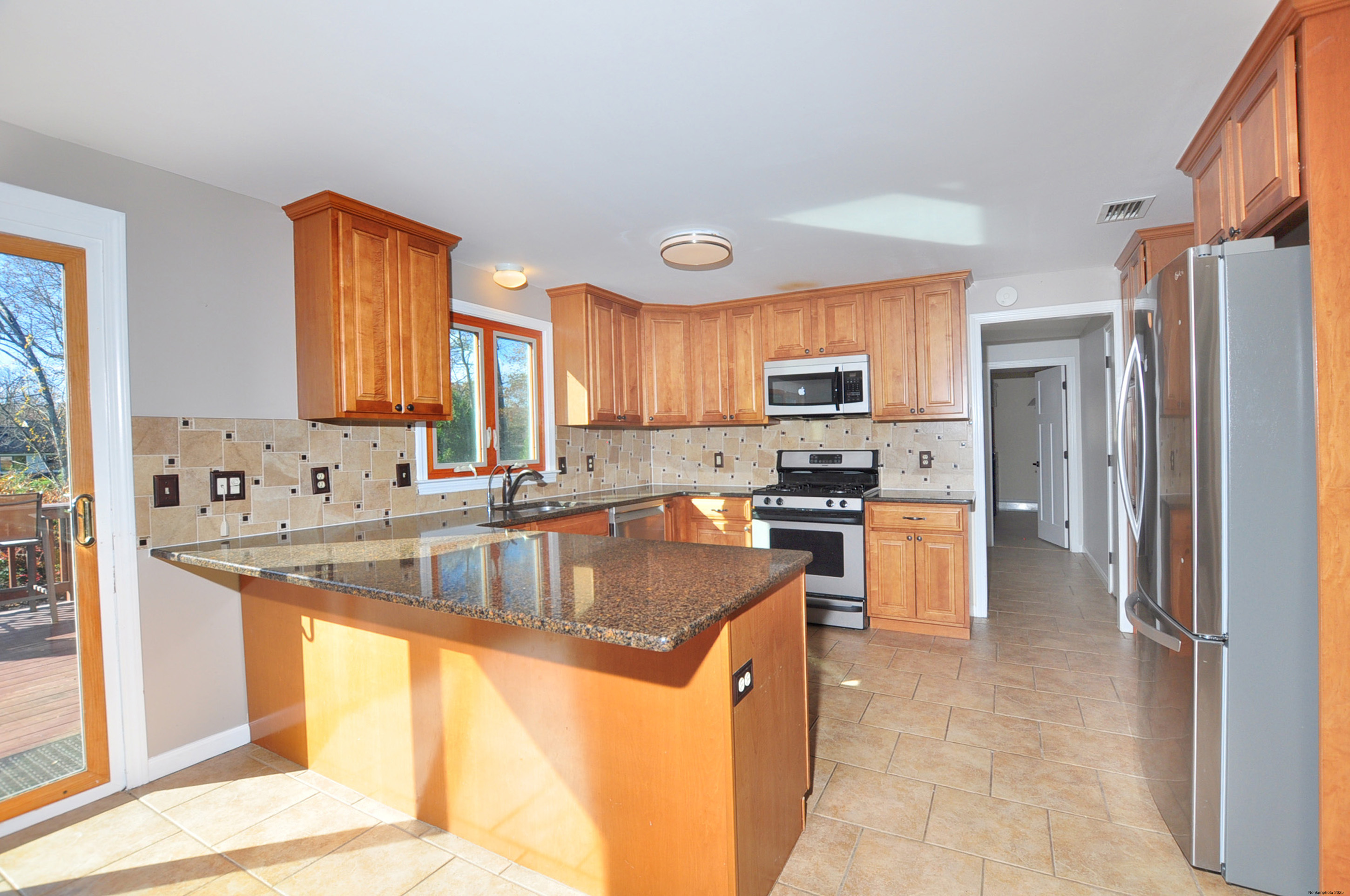 16 Virginia Lane Farmington, CT 06085 - Photo 10 of 40 a kitchen with stainless steel appliances granite countertop a sink a stove and a refrigerator