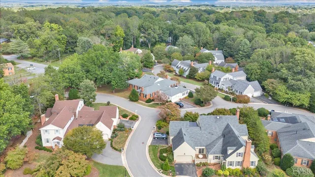an aerial view of a house with a yard basket ball court and outdoor seating