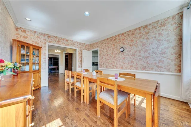 a dining hall with stainless steel appliances granite countertop a granite counter tops and a view of living room with a large window