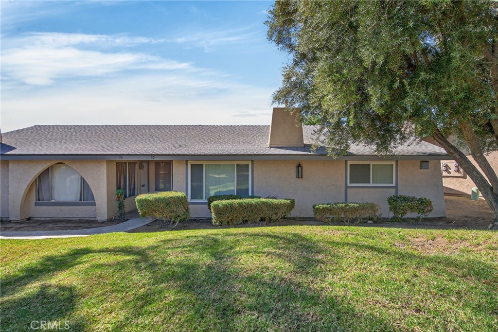 2891 Canyon Crest, Unit 32 Riverside, CA 92507 - Photo 1 of 27 a front view of a house with a yard