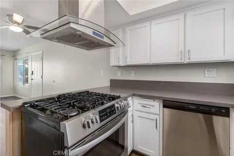 a white stove top oven sitting inside of a kitchen
