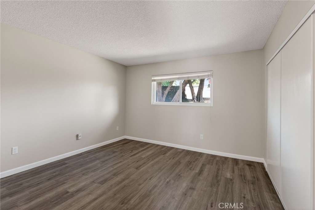 2891 Canyon Crest, Unit 32 Riverside, CA 92507 - Photo 15 of 27 a view of room with window and hardwood floor