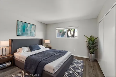 a bedroom with a bed and a potted plant