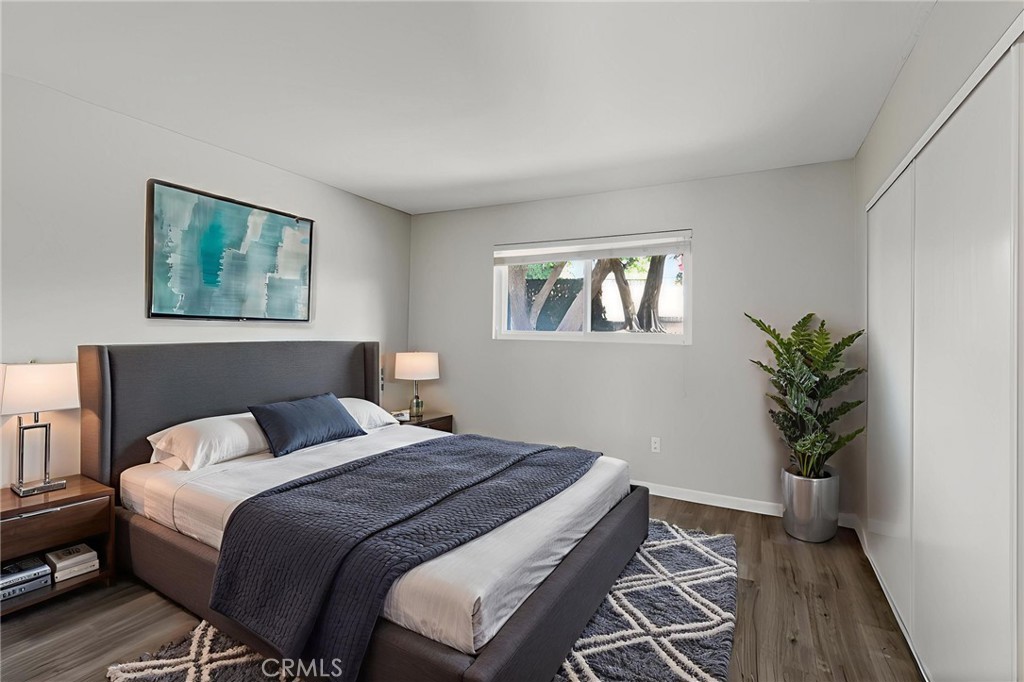 2891 Canyon Crest, Unit 32 Riverside, CA 92507 - Photo 16 of 27 a bedroom with a bed and a potted plant