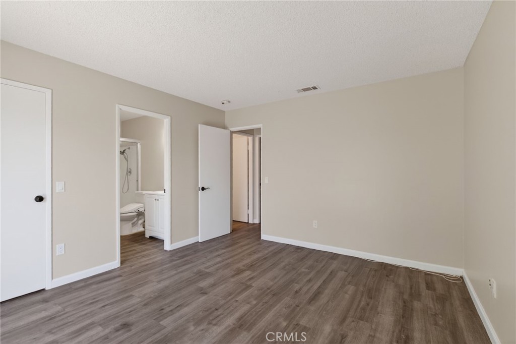 2891 Canyon Crest, Unit 32 Riverside, CA 92507 - Photo 18 of 27 a view of an empty room with wooden floor and closet