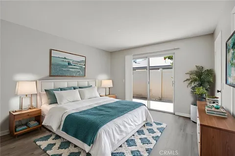 a bedroom with a bed and a potted plant