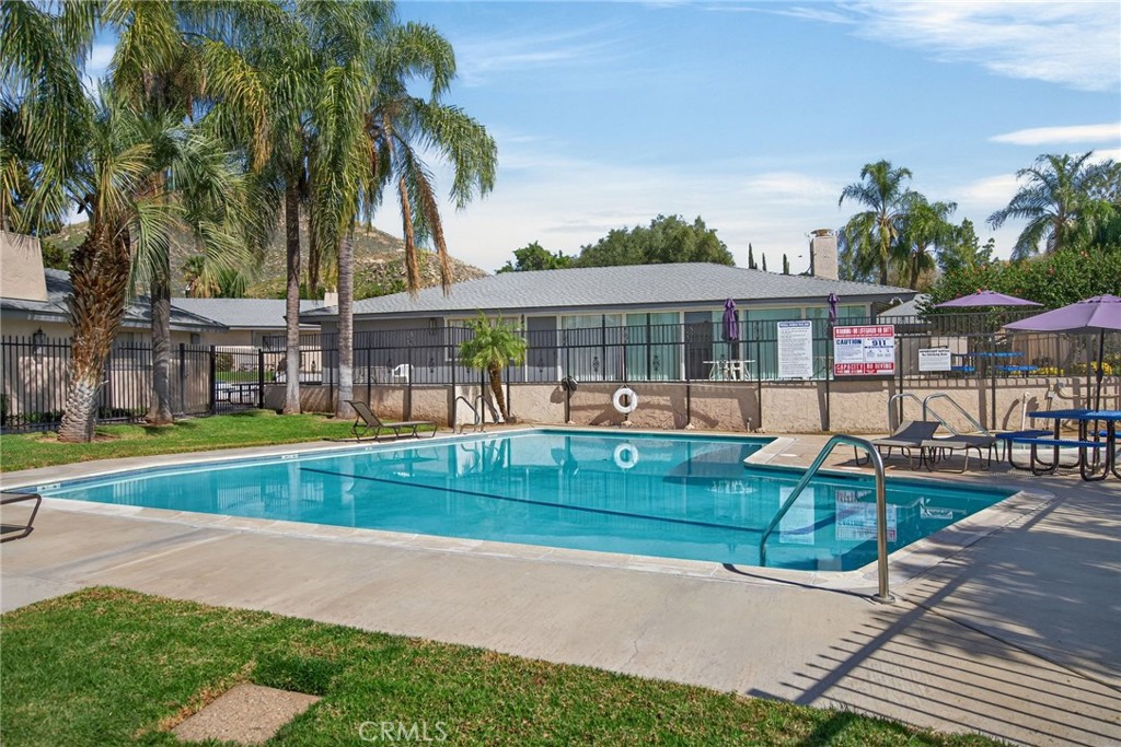 2891 Canyon Crest, Unit 32 Riverside, CA 92507 - Photo 25 of 27 a view of a house and a yard with a swimming pool