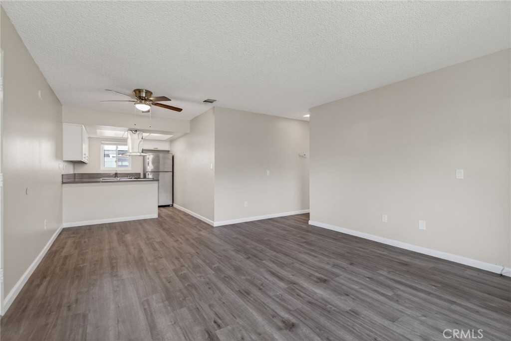 2891 Canyon Crest, Unit 32 Riverside, CA 92507 - Photo 7 of 27 a view of a kitchen with a sink and wooden floor