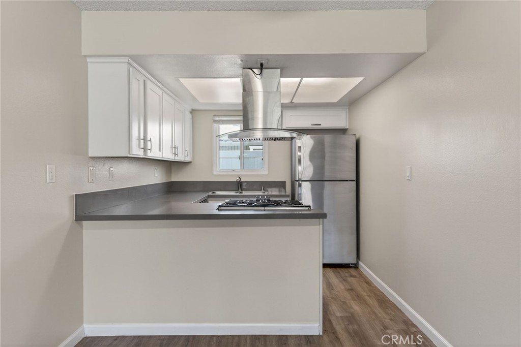 2891 Canyon Crest, Unit 32 Riverside, CA 92507 - Photo 9 of 27 a kitchen with stainless steel appliances granite countertop a sink and a stove