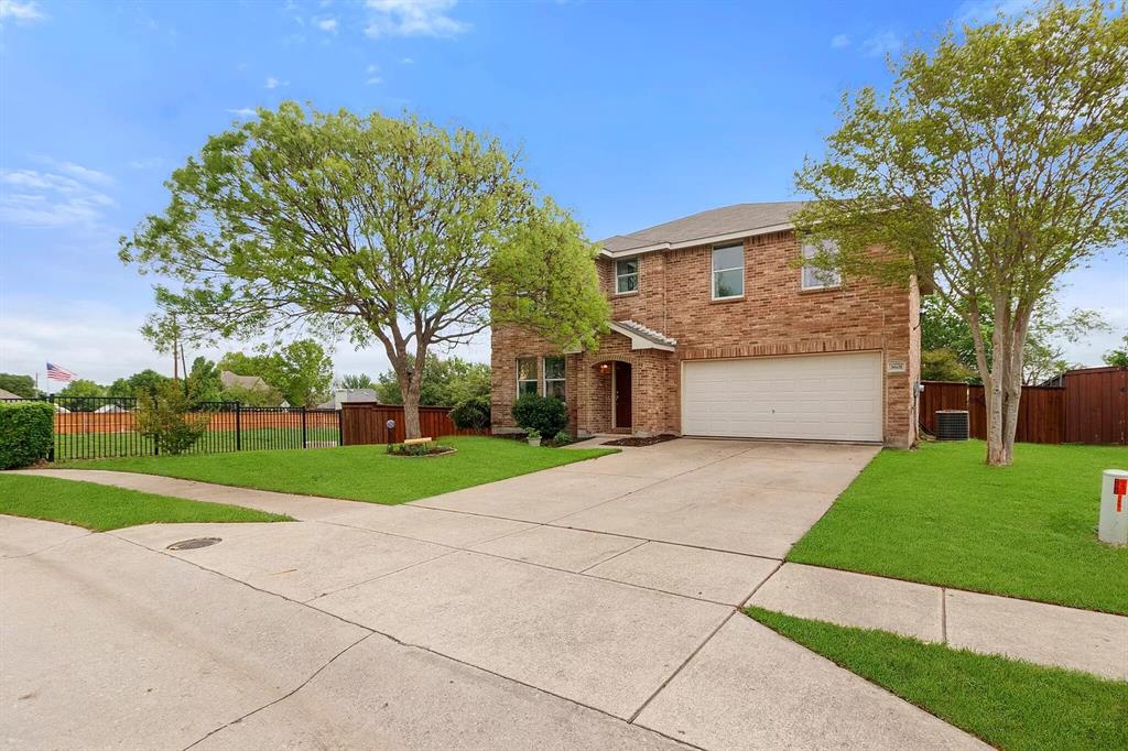 3601 McClintick Road McKinney, TX 75070 - Photo 2 of 24 a front view of a house with a yard and garage