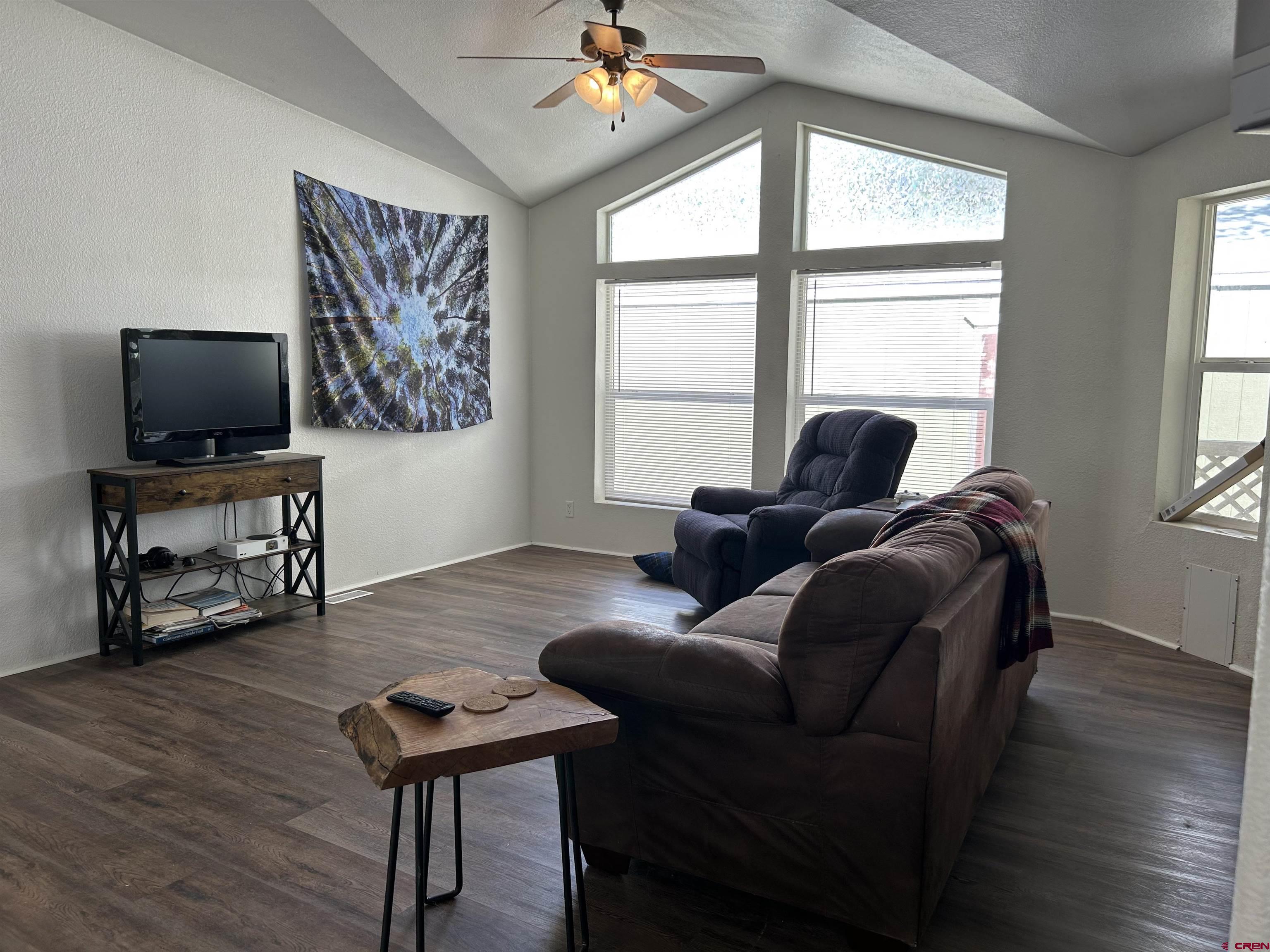 28260 Highway 160, Unit 1 Cortez, CO 81321 - Photo 11 of 21 a living room with furniture and a flat screen tv