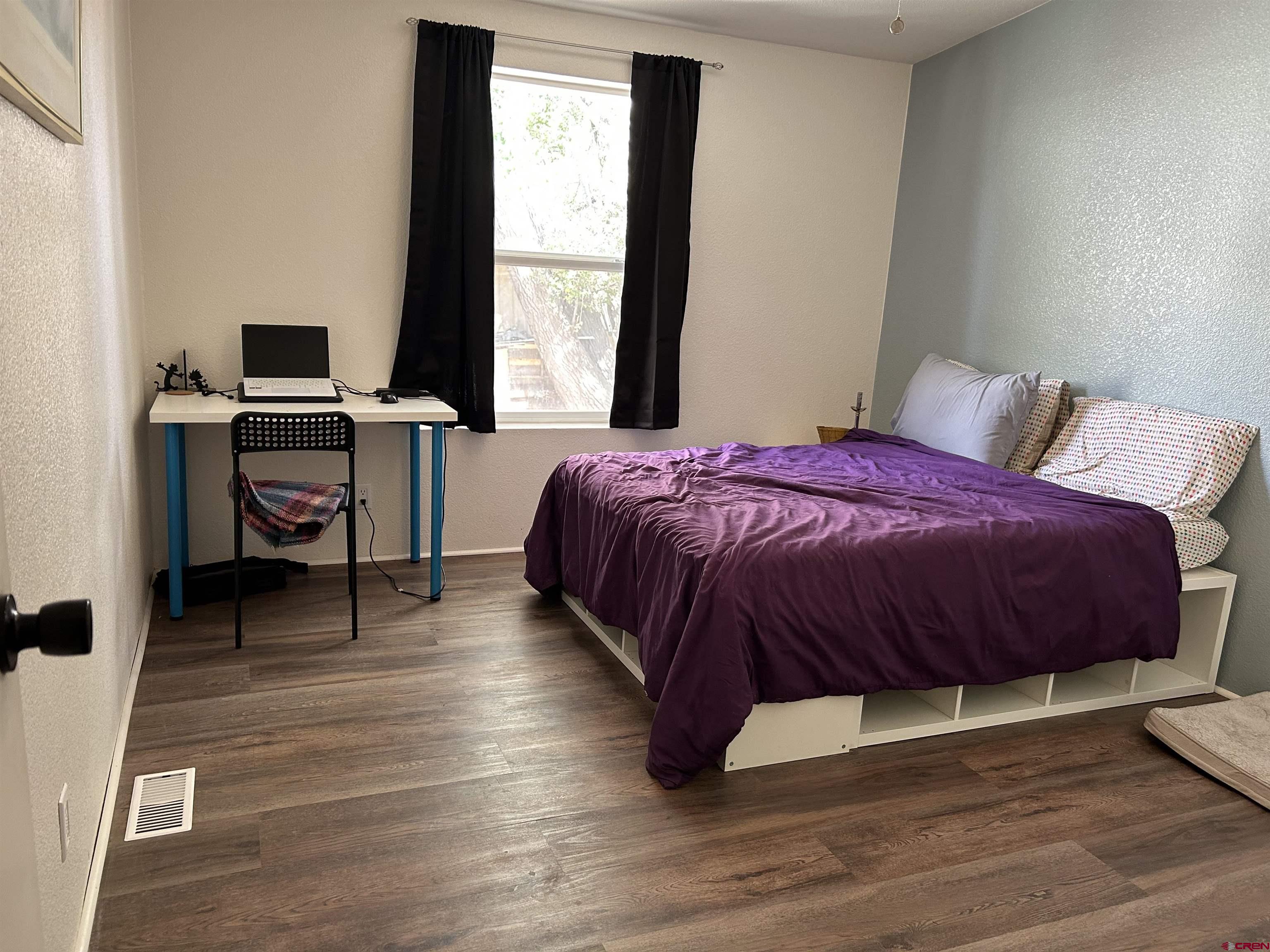 28260 Highway 160, Unit 1 Cortez, CO 81321 - Photo 12 of 21 a spacious bedroom with a bed and a window