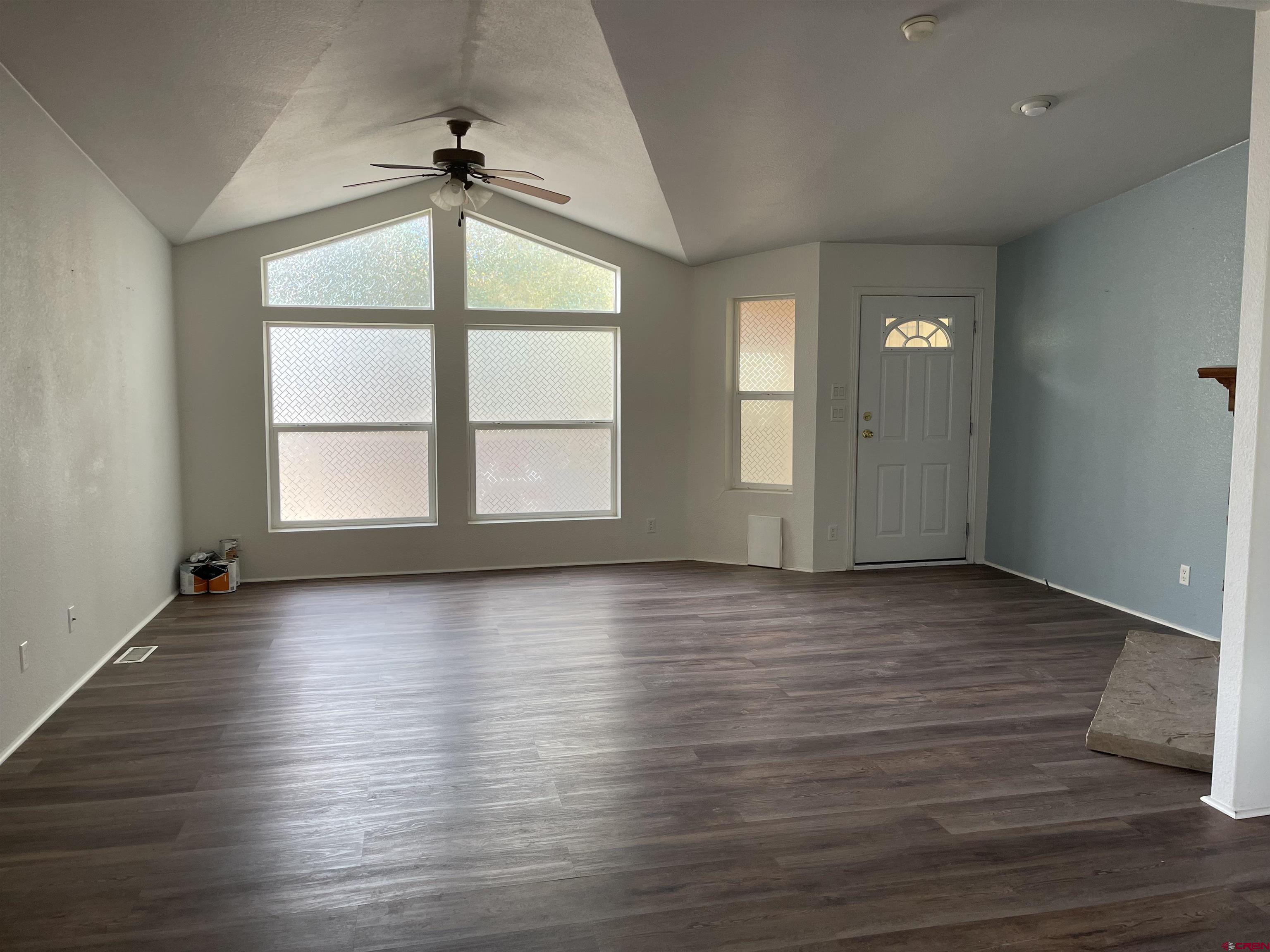 28260 Highway 160, Unit 1 Cortez, CO 81321 - Photo 20 of 21 an empty room with wooden floor chandelier and windows