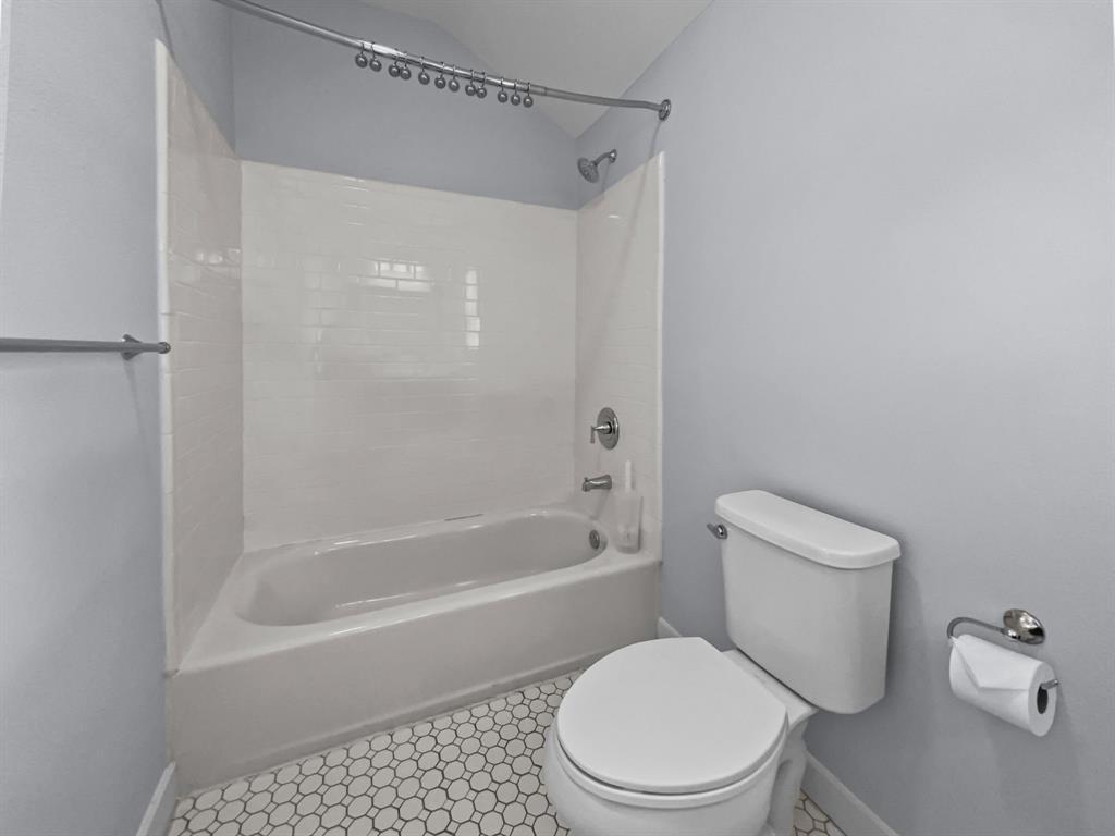 815 Stonecrest Road Argyle, TX 76226 - Photo 7 of 17 Bathtub with white subway tile surround, chrome fixtures, and a curved shower rod
