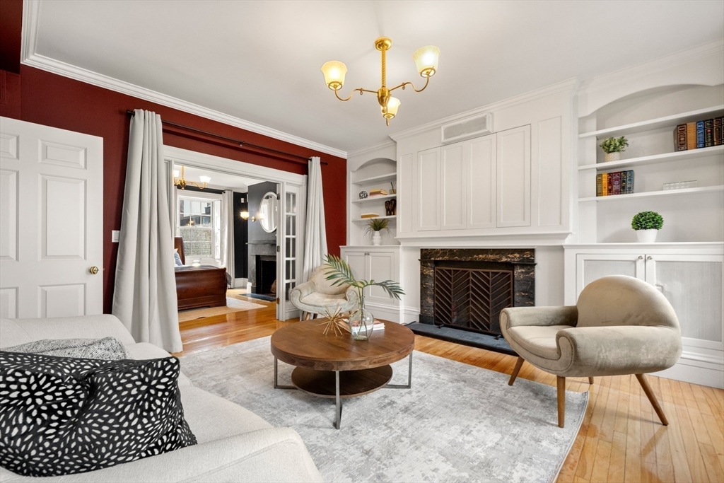 14 Pinckney Street Boston, MA 02114 - Photo 11 of 27 a living room with furniture a fireplace and a chandelier