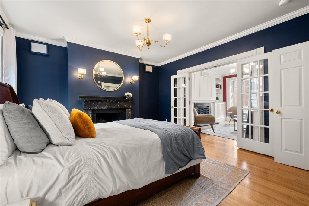 14 Pinckney Street Boston, MA 02114 - Photo 12 of 27 a bedroom with a bed mirror and painting on the wall