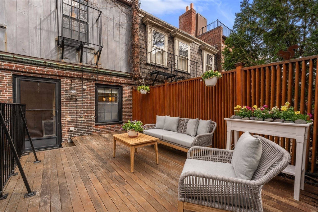 14 Pinckney Street Boston, MA 02114 - Photo 19 of 27 a view of a patio with couches table and chairs and wooden floor