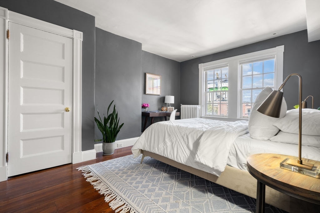 14 Pinckney Street Boston, MA 02114 - Photo 22 of 27 a bedroom with a bed and wooden floor
