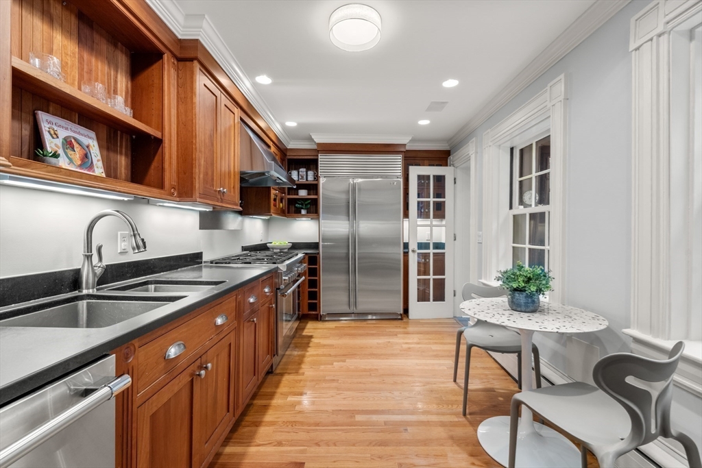 14 Pinckney Street Boston, MA 02114 - Photo 8 of 27 a kitchen with stainless steel appliances granite countertop a sink and a refrigerator