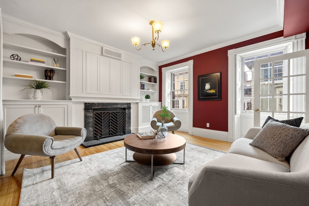 14 Pinckney Street Boston, MA 02114 - Photo 10 of 27 a living room with furniture a fireplace and a chandelier