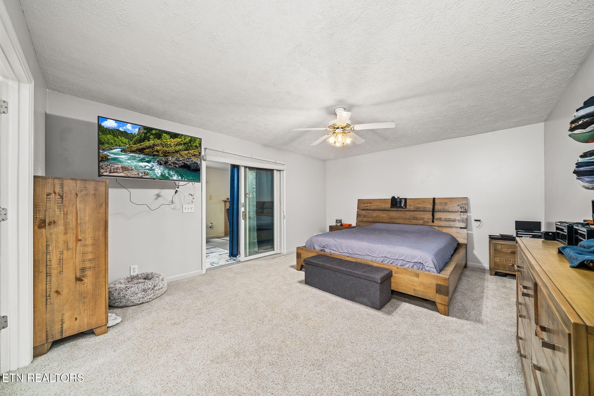 614 West Creston Road Crossville, TN 38571 - Photo 15 of 47 a bedroom with a bed and a chandelier