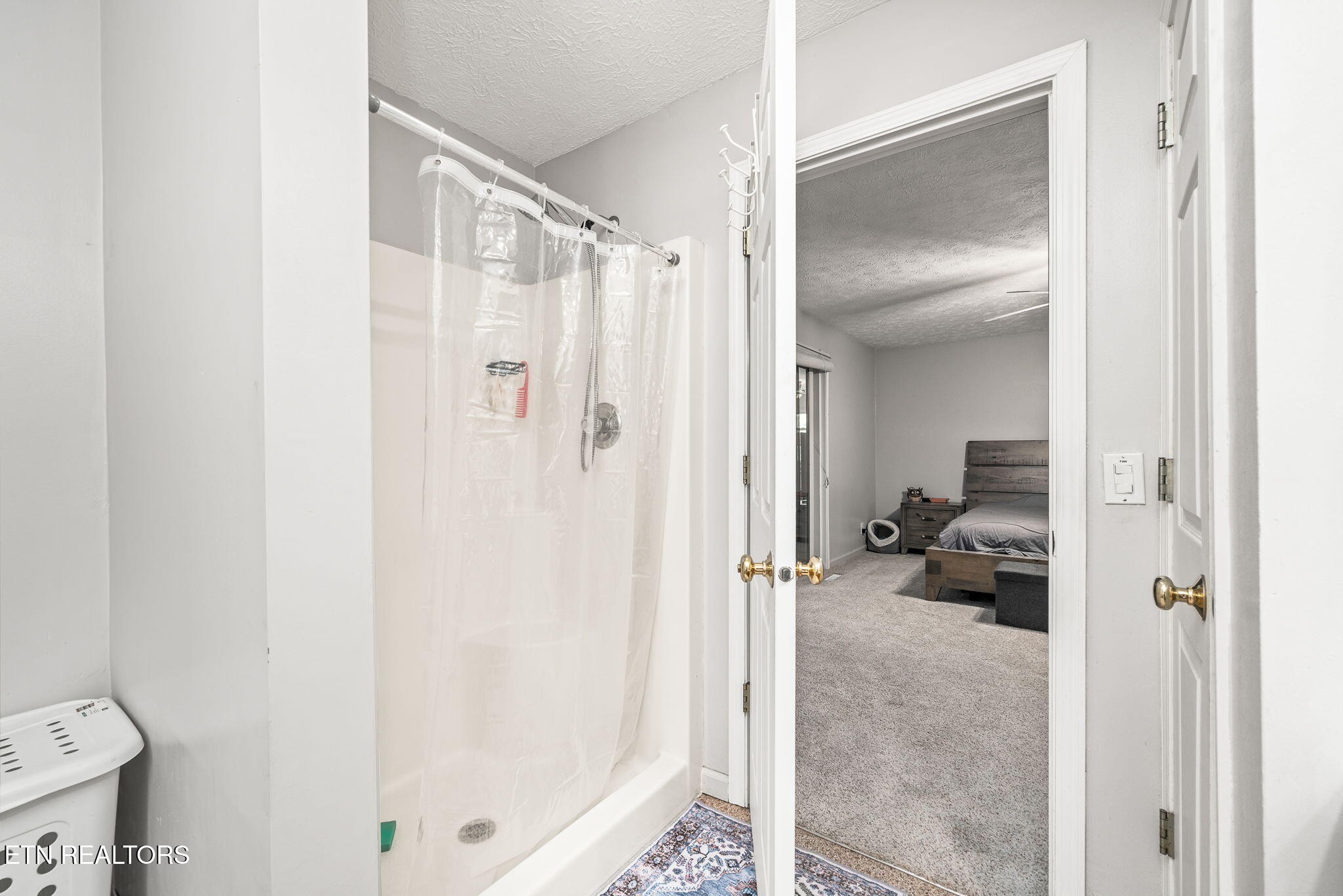 614 West Creston Road Crossville, TN 38571 - Photo 17 of 47 a bathroom with a glass door shower and a toilet