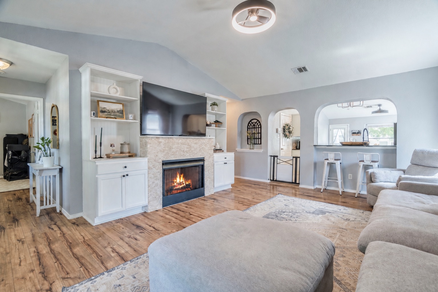 175 Wetzel Kyle, TX 78640 - Photo 9 of 27 A comforting fireplace anchors this spacious room with vaulted ceilings and beautiful hardwood flooring.