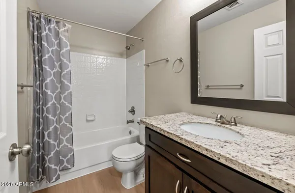 a kitchen with granite countertop cabinets stainless steel appliances and wooden floor