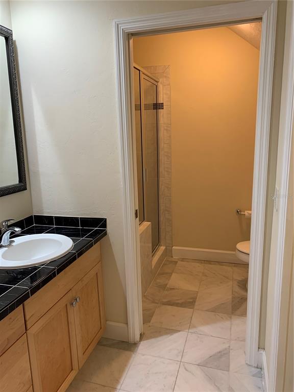 187 Southwest 129 Terrace Newberry, FL 32669 - Photo 14 of 39 a bathroom with a granite countertop sink and a mirror