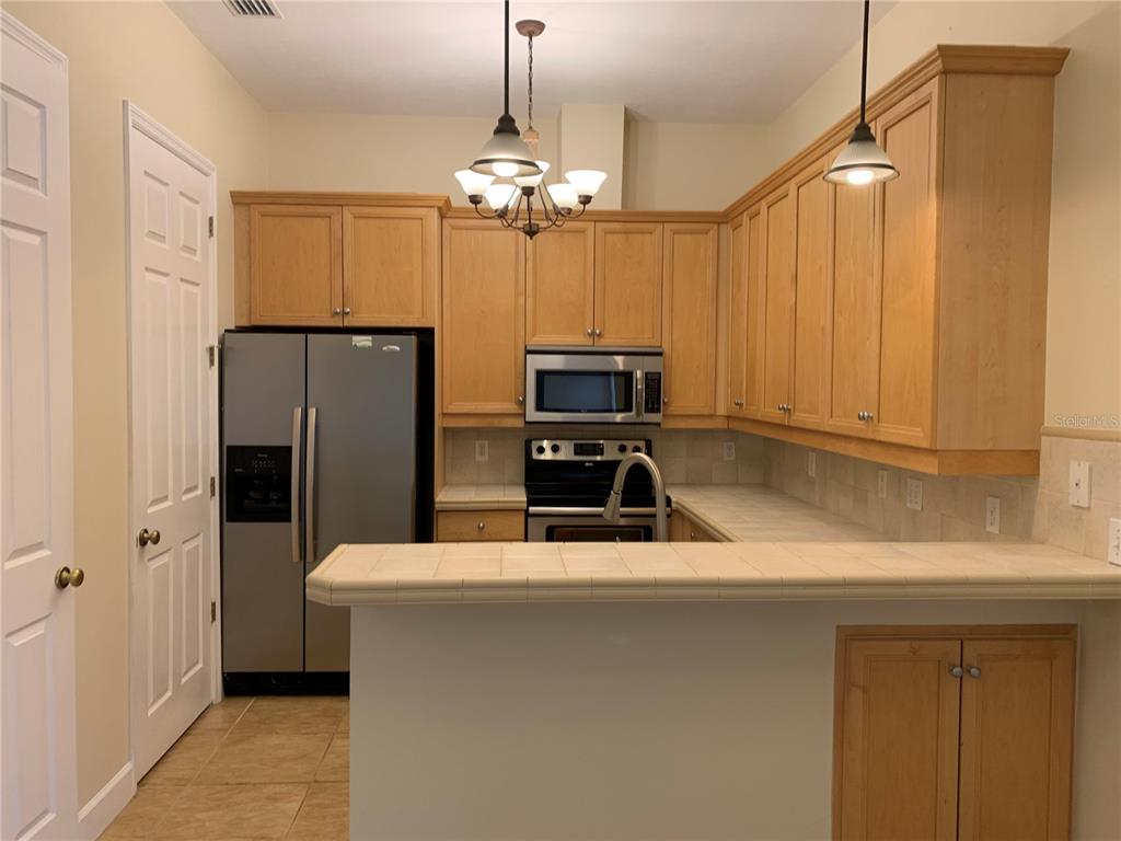 187 Southwest 129 Terrace Newberry, FL 32669 - Photo 21 of 39 a kitchen with kitchen island a counter space a sink appliances and cabinets