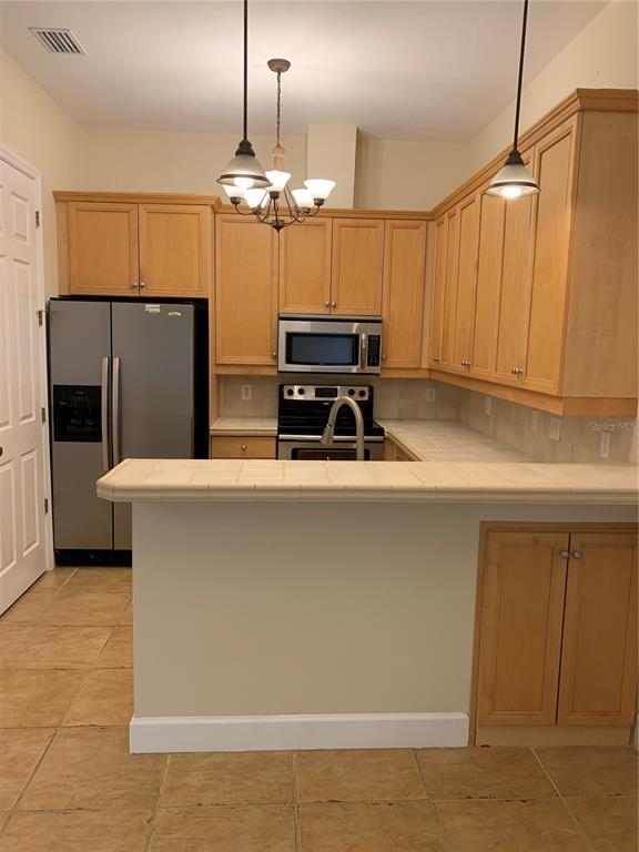 187 Southwest 129 Terrace Newberry, FL 32669 - Photo 22 of 39 a kitchen with stainless steel appliances a refrigerator and a sink
