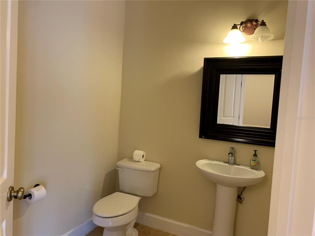 187 Southwest 129 Terrace Newberry, FL 32669 - Photo 28 of 39 a bathroom with a toilet sink and mirror