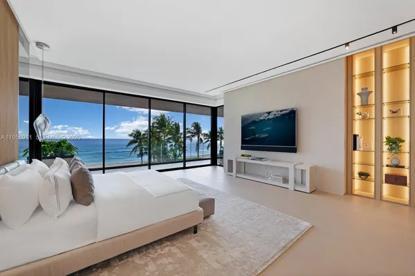 a bed sitting in a spacious bedroom next to a window