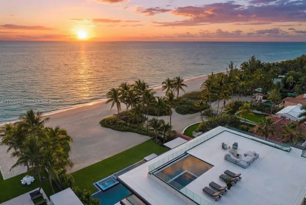a living room with fireplace furniture and a large window