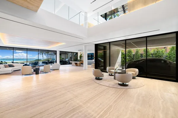 a view of swimming pool with a table and chairs under an umbrella