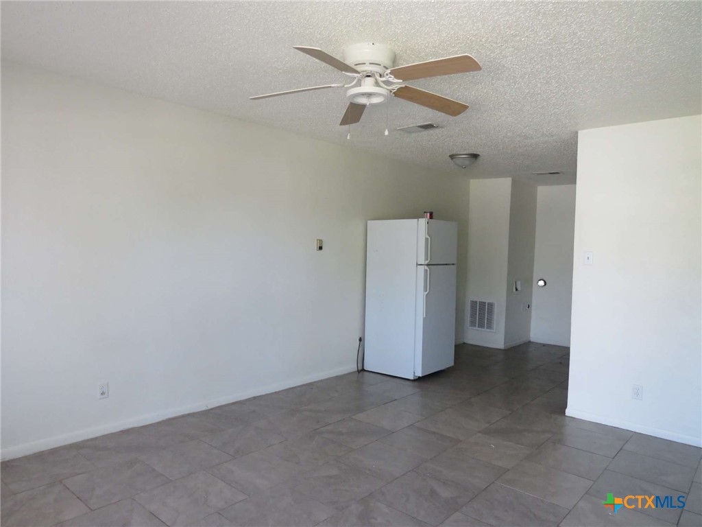 1513 Janis Drive, Unit A Killeen, TX 76549 - Photo 3 of 6 an empty room with a kitchen