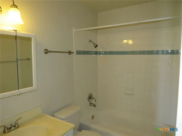 a bathroom with a shower and a toilet