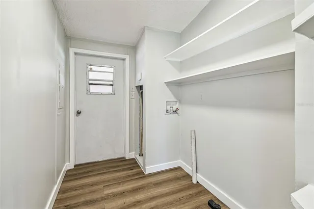 a view of a room with wooden floor
