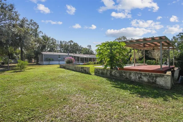 a view of a backyard with sitting area