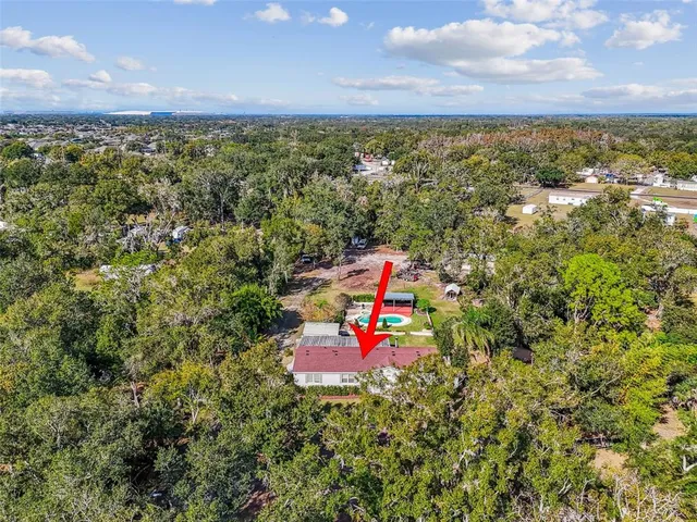 an aerial view of a houses with a yard