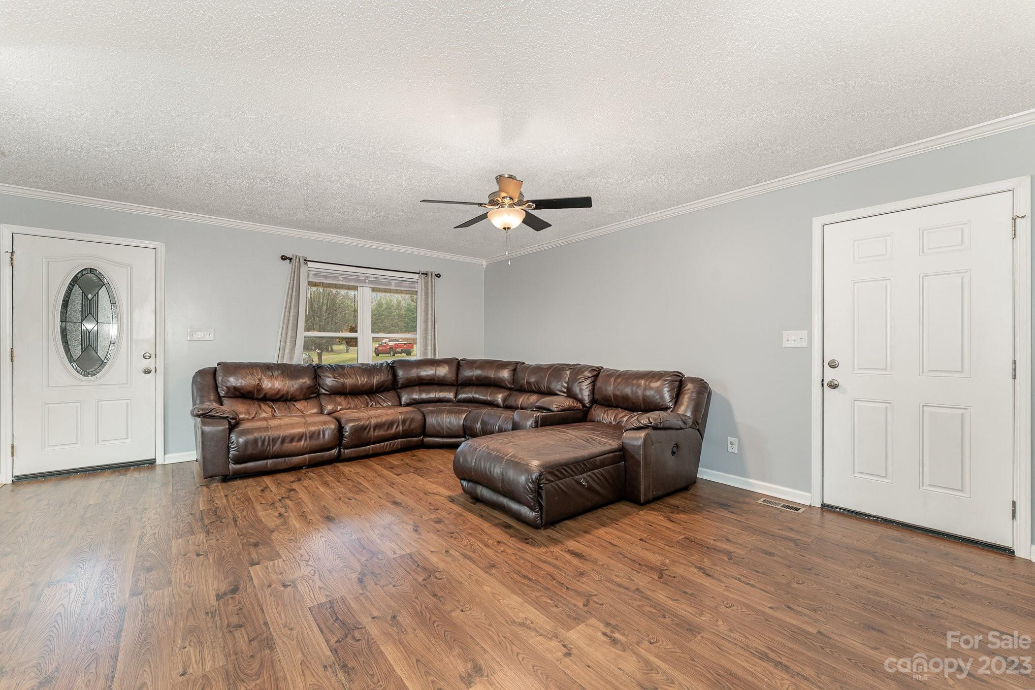 873 Gladstone Road Mocksville, NC 27028 - Photo 13 of 29 a living room with furniture and a wooden floor