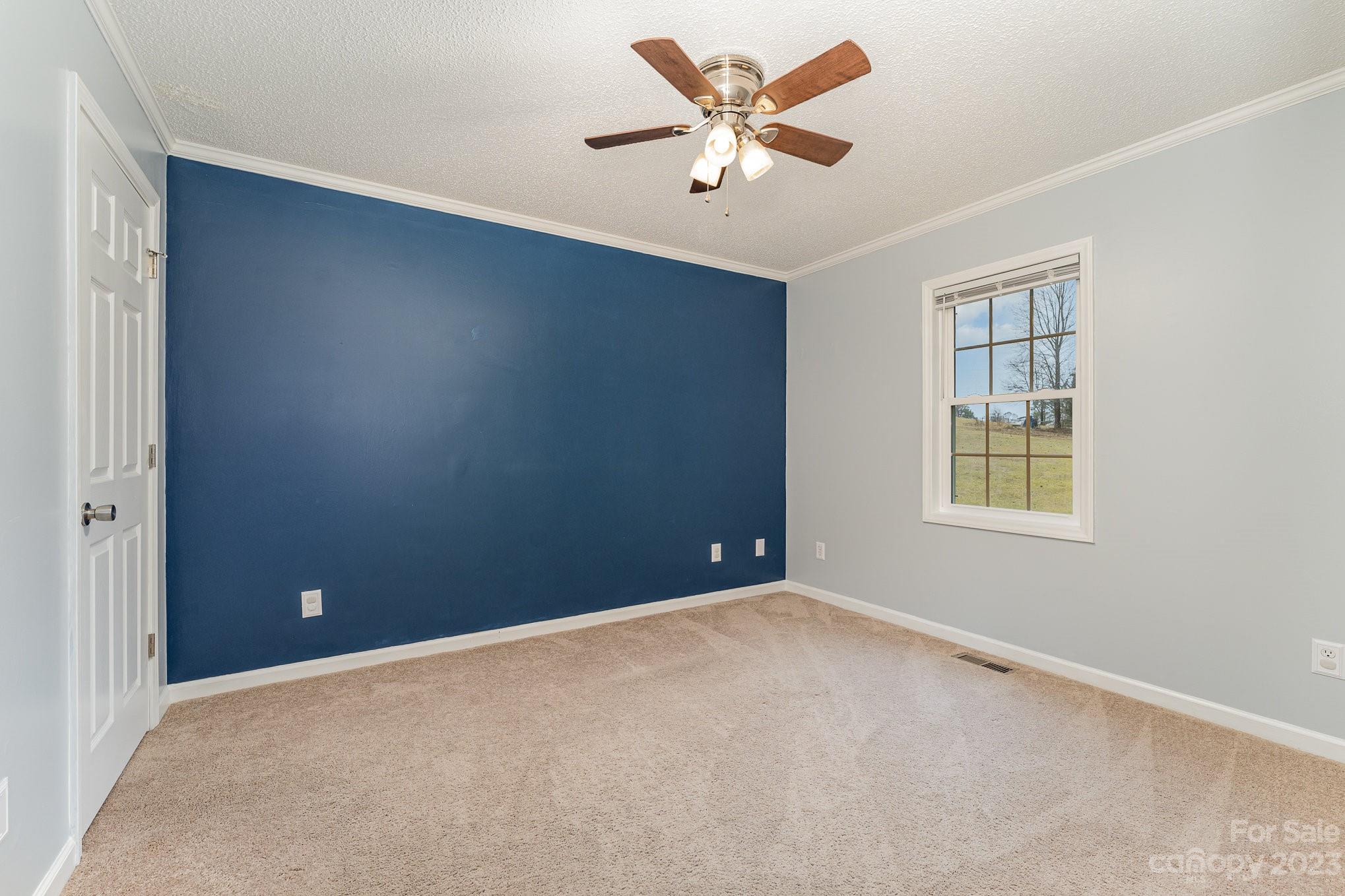 873 Gladstone Road Mocksville, NC 27028 - Photo 17 of 29 an empty room with a window and a ceiling fan