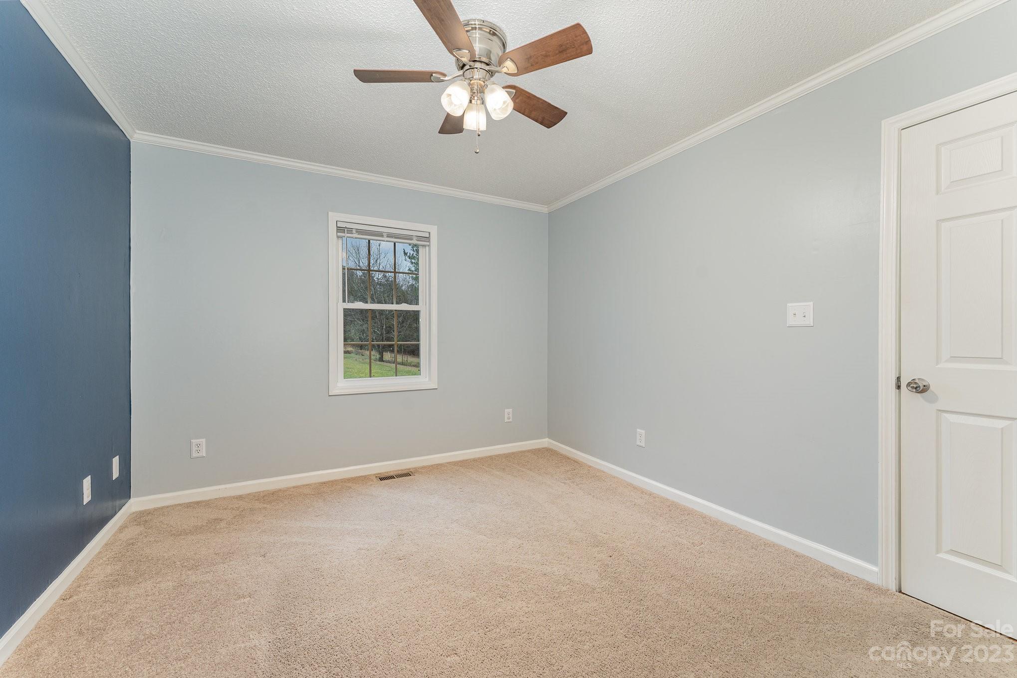 873 Gladstone Road Mocksville, NC 27028 - Photo 18 of 29 an empty room with a window and a fan