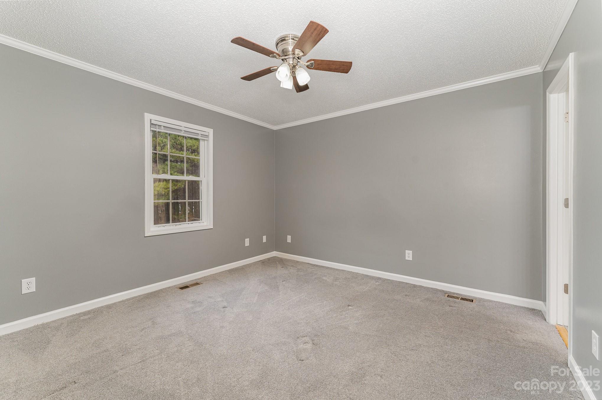 873 Gladstone Road Mocksville, NC 27028 - Photo 20 of 29 an empty room with window and ceiling fan