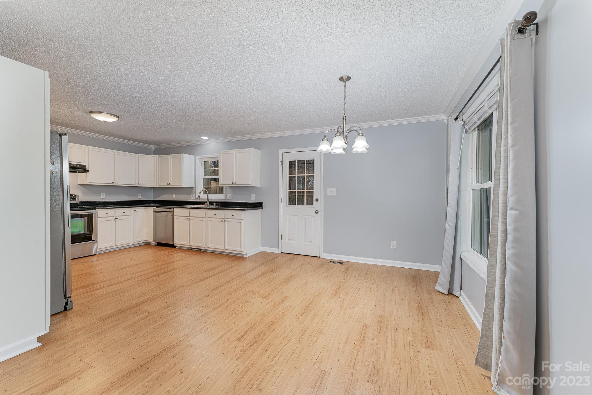 873 Gladstone Road Mocksville, NC 27028 - Photo 7 of 29 a view of a kitchen with a sink and wooden floor kitchen view